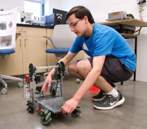 Student working with a robot